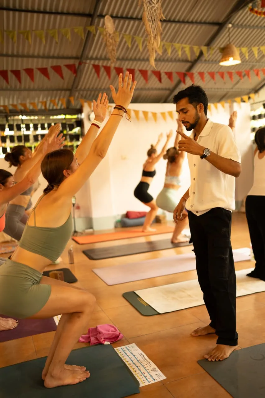Abhi Nautiyal teaching alignment during a group yoga class